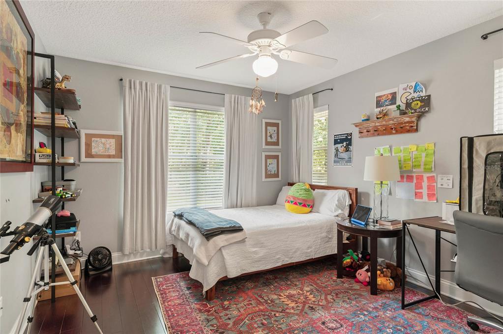 133 Ross Lake Lane Sanford, FL 32771 - Photo 22 of 32 a room that has a bed and a chandelier