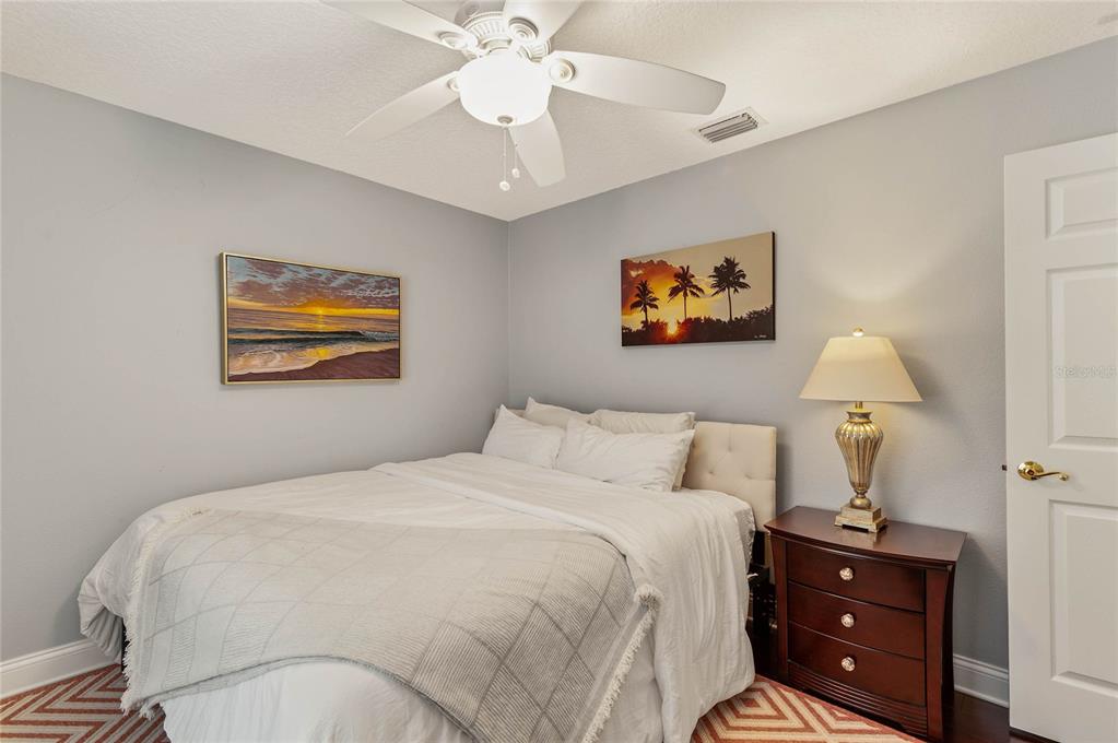 133 Ross Lake Lane Sanford, FL 32771 - Photo 23 of 32 a bedroom with a bed and a chandelier