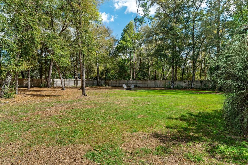 133 Ross Lake Lane Sanford, FL 32771 - Photo 29 of 32 a view of outdoor space with deck and trees