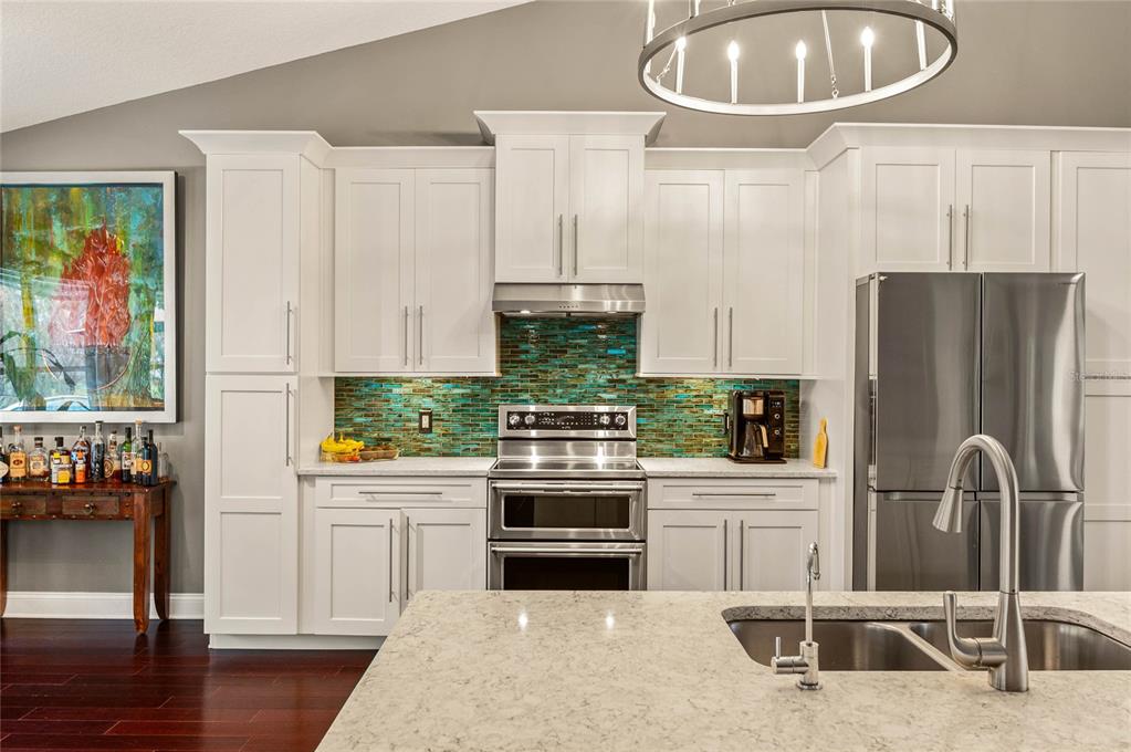 133 Ross Lake Lane Sanford, FL 32771 - Photo 5 of 32 a kitchen with stainless steel appliances a stove a sink and a refrigerator