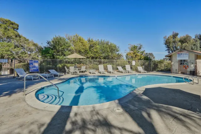 a view of a swimming pool with an outdoor seating