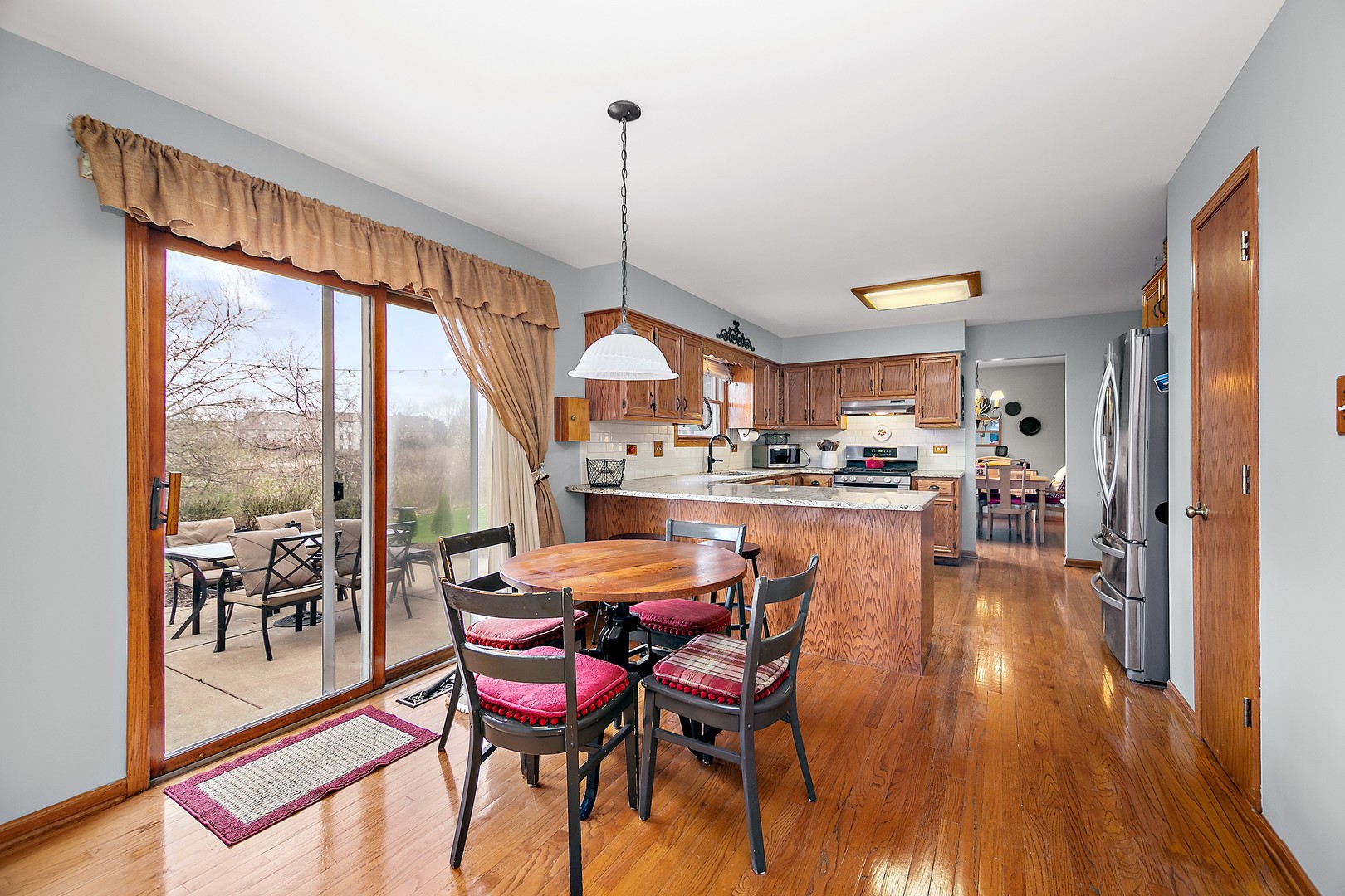 16200 Kingsport Road Orland Park, IL 60467 - Photo 7 of 32 a dining room with furniture a chandelier and wooden floor