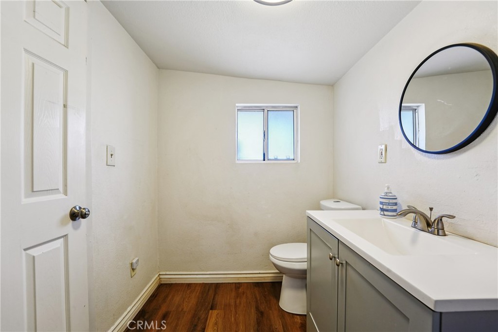 313 North 3rd Street Banning, CA 92220 - Photo 15 of 30 a bathroom with a sink a toilet and a mirror