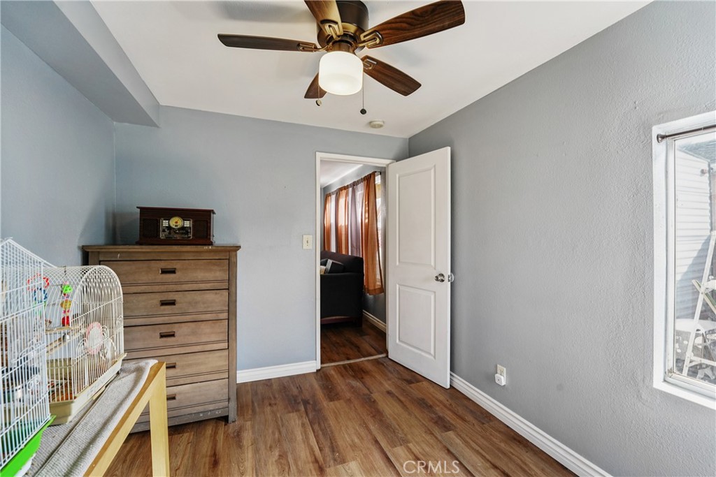 313 North 3rd Street Banning, CA 92220 - Photo 17 of 30 wooden floor in an empty room with a window