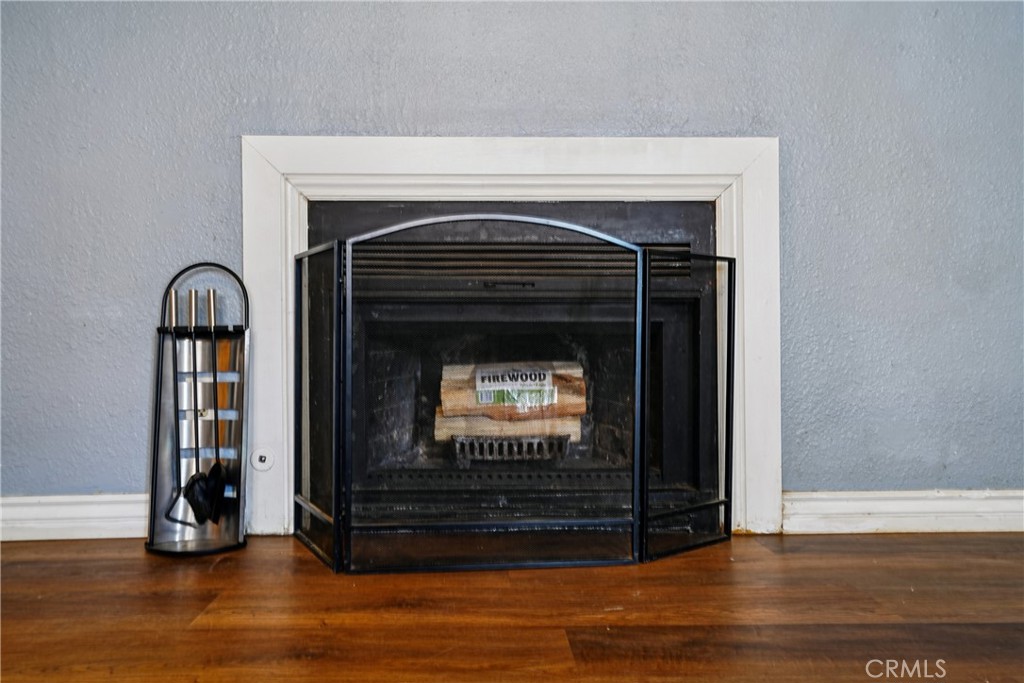 313 North 3rd Street Banning, CA 92220 - Photo 18 of 30 a living room with fireplace and a wooden floor