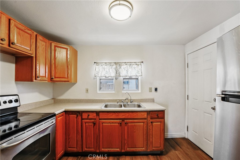 313 North 3rd Street Banning, CA 92220 - Photo 8 of 30 a kitchen with stainless steel appliances granite countertop a sink stove and cabinets