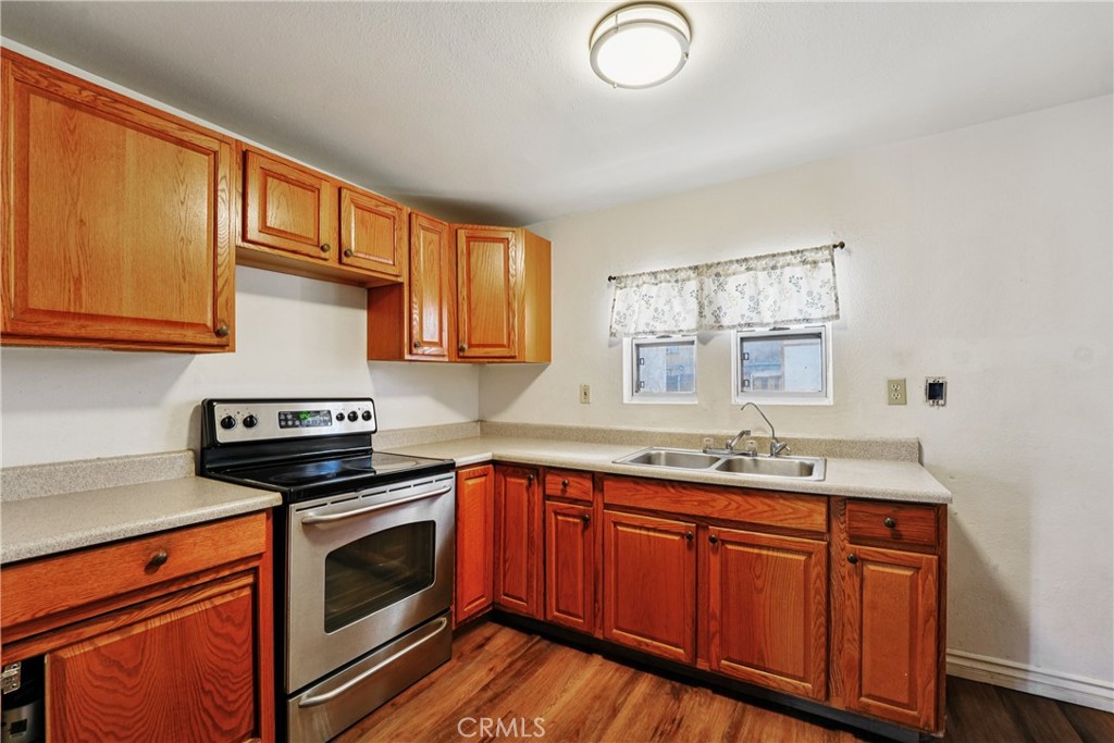 313 North 3rd Street Banning, CA 92220 - Photo 10 of 30 a kitchen with stainless steel appliances granite countertop a sink stove and cabinets