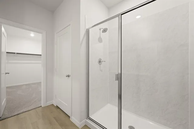 a bathroom with a glass shower door