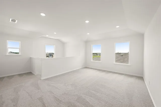 an empty room with a empty space and windows