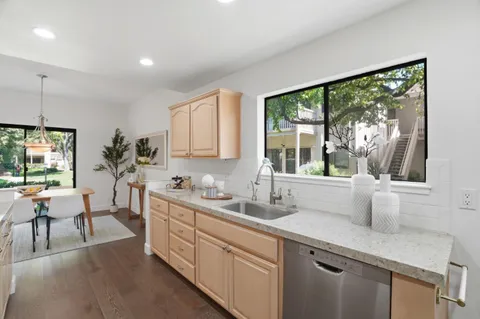 a kitchen with stainless steel appliances granite countertop a stove microwave and cabinets