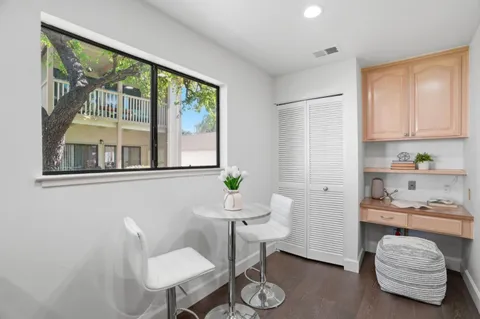 a kitchen with refrigerator and dining table