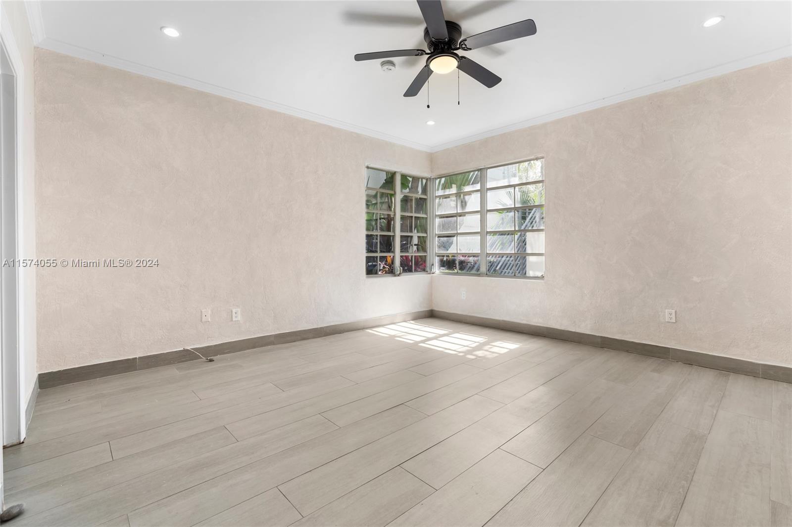934 16th Street, Unit 5 Miami Beach, FL 33139 - Photo 11 of 22 an empty room with windows and ceiling fan