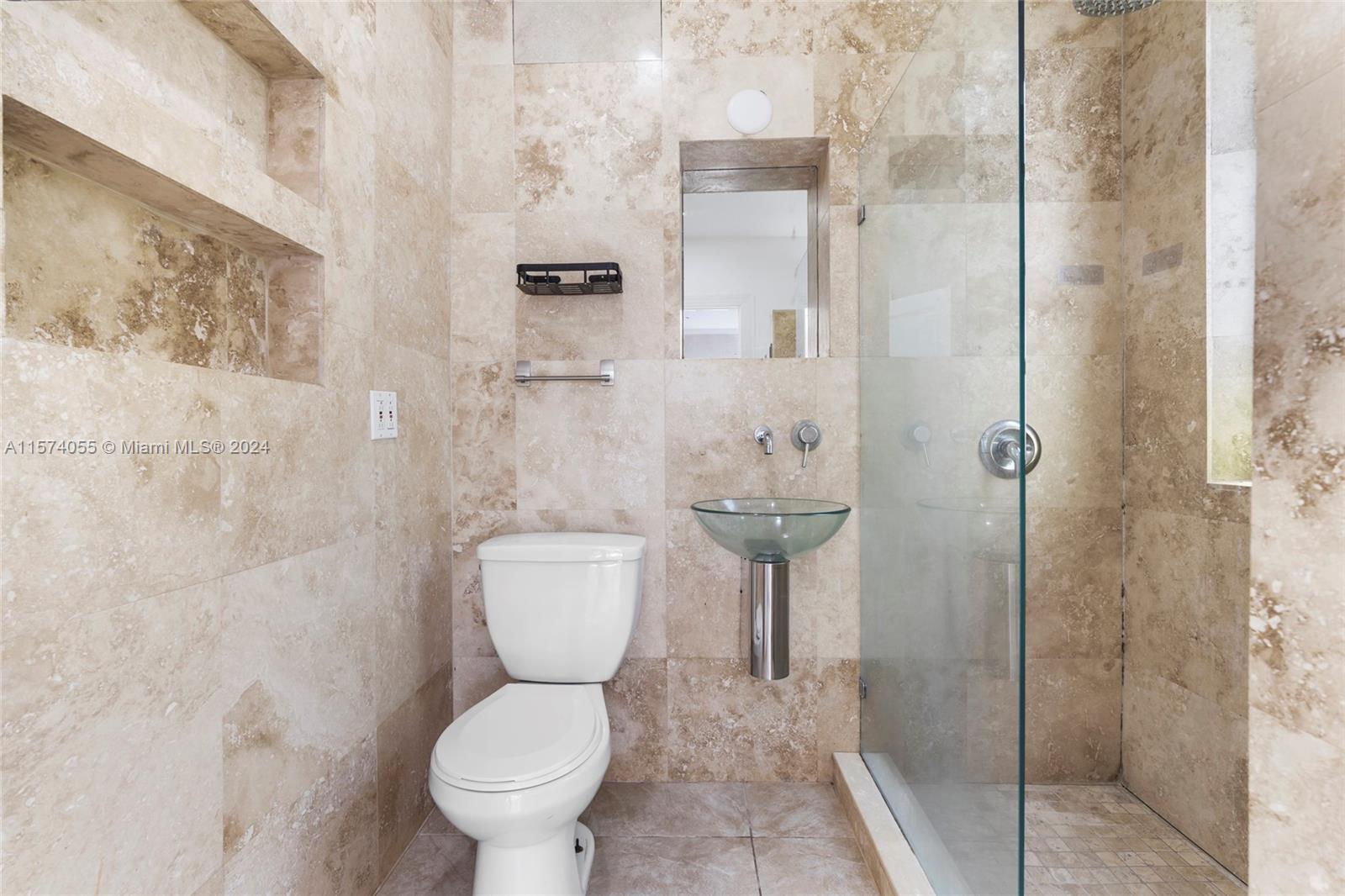 934 16th Street, Unit 5 Miami Beach, FL 33139 - Photo 12 of 22 a bathroom with a toilet and a shower
