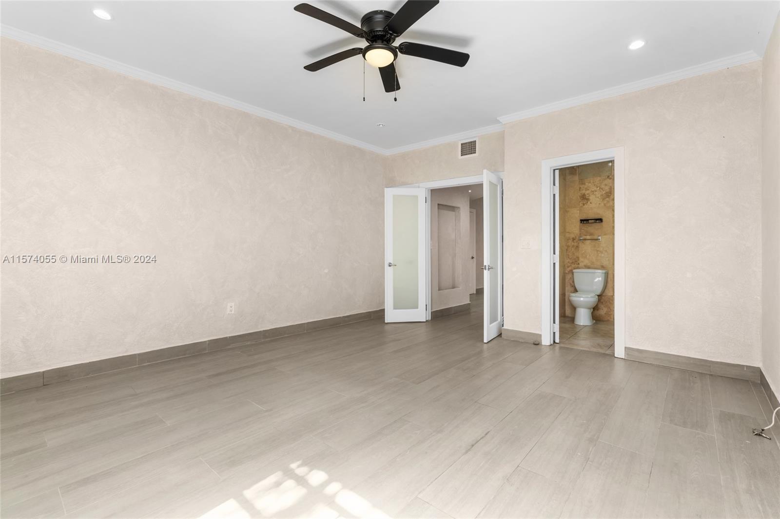 934 16th Street, Unit 5 Miami Beach, FL 33139 - Photo 13 of 22 an empty room with closet and windows