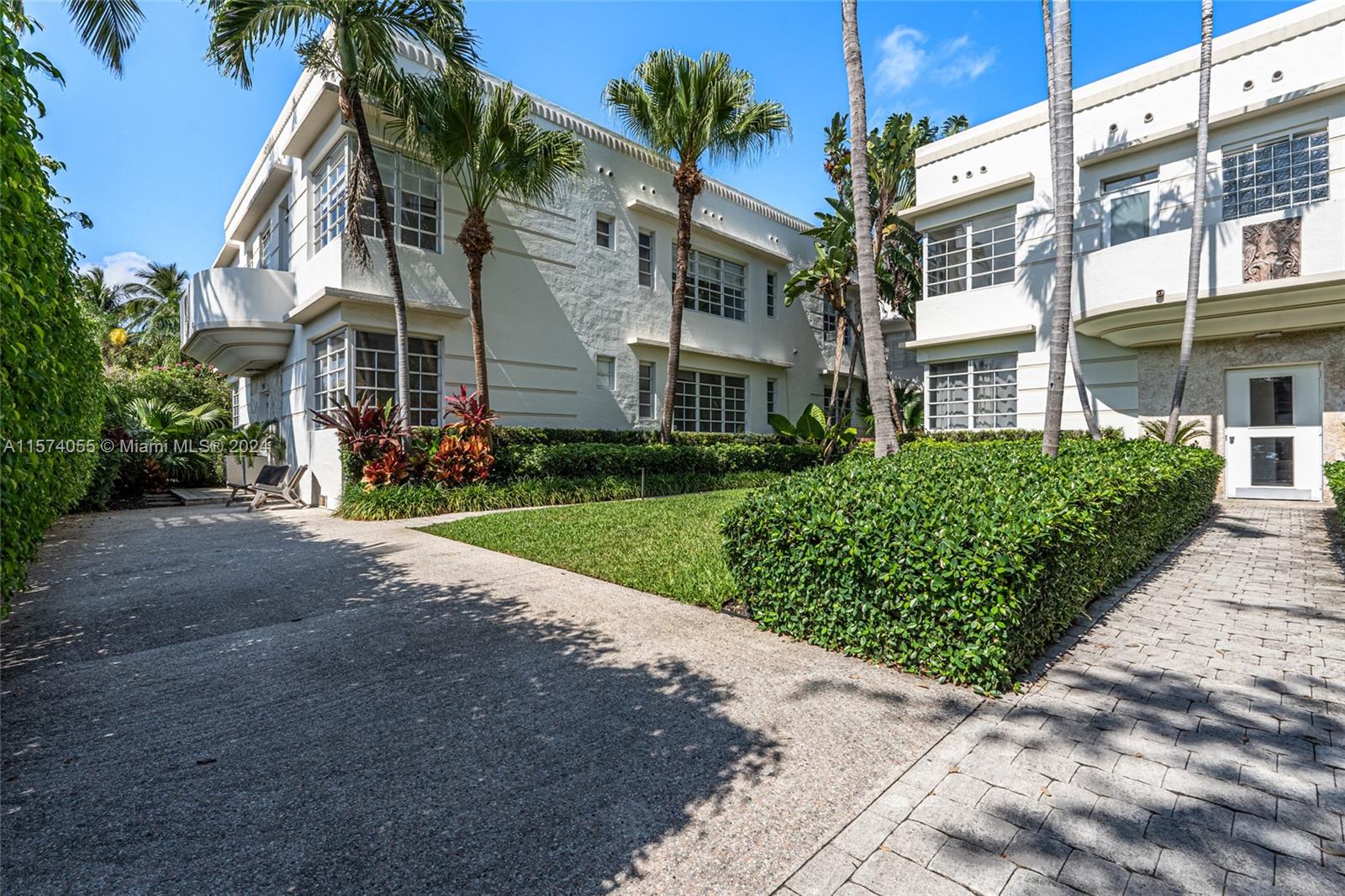 934 16th Street, Unit 5 Miami Beach, FL 33139 - Photo 17 of 22 a front view of a residential apartment building with a yard