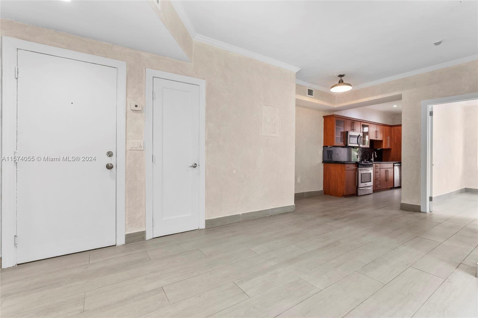 934 16th Street, Unit 5 Miami Beach, FL 33139 - Photo 3 of 22 a view of a livingroom with kitchen and chandelier