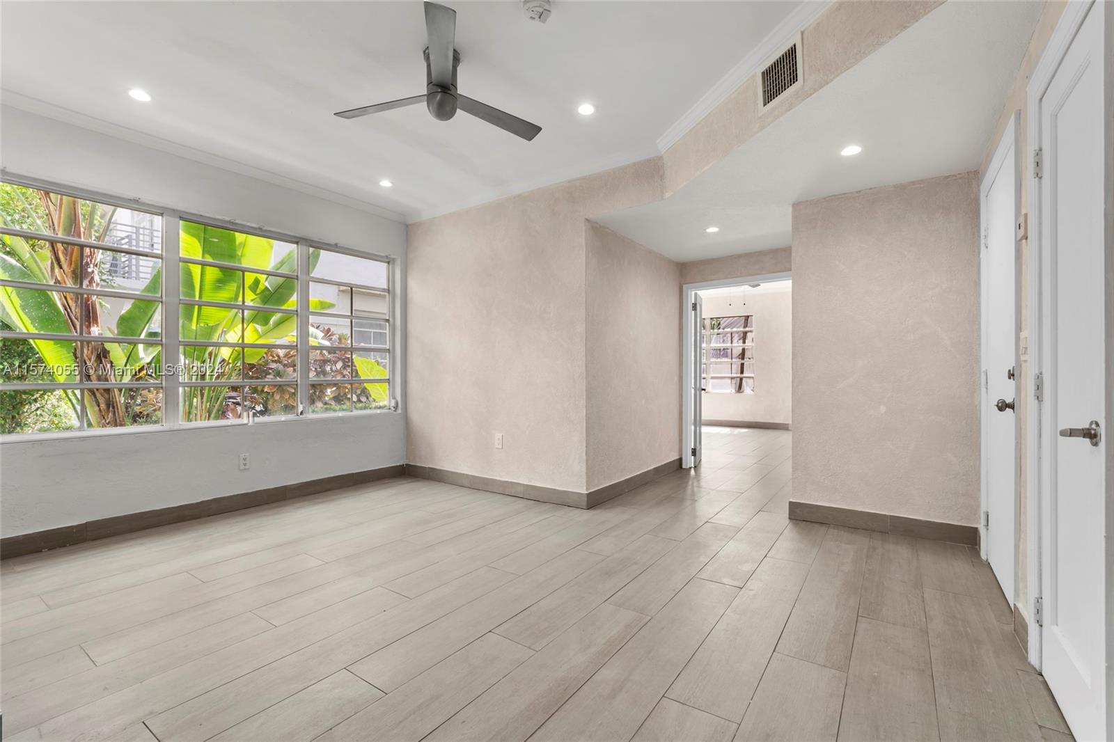 934 16th Street, Unit 5 Miami Beach, FL 33139 - Photo 4 of 22 an empty room with wooden floor and natural light