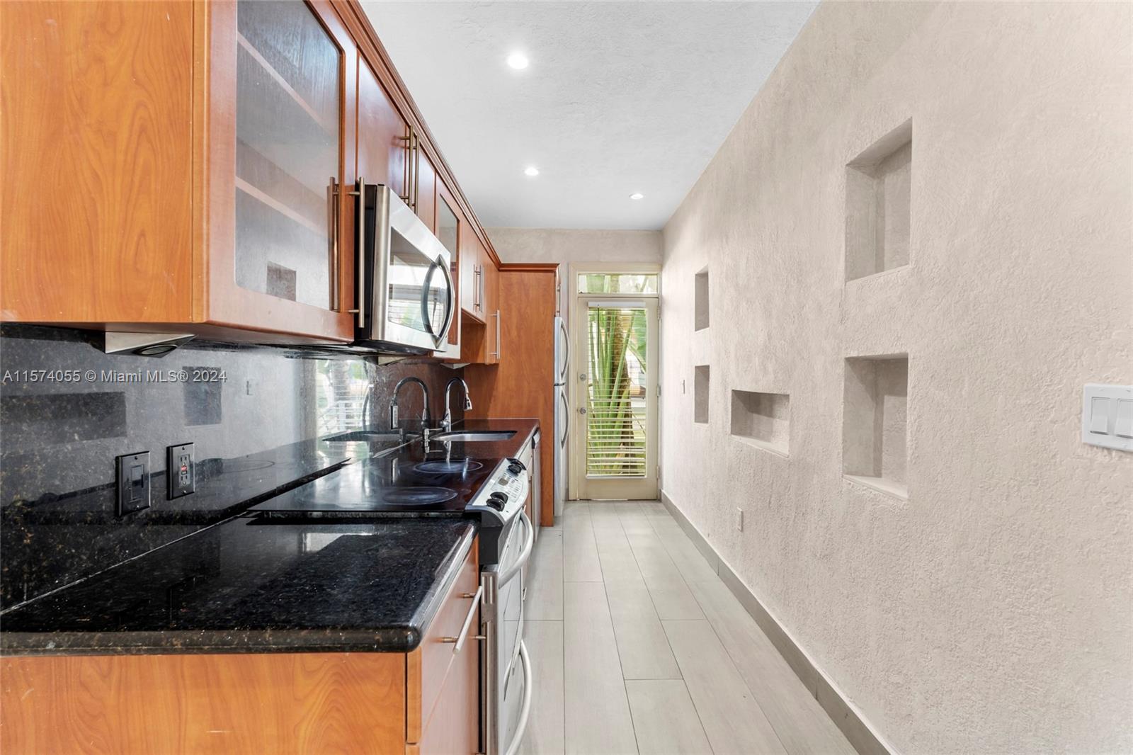 934 16th Street, Unit 5 Miami Beach, FL 33139 - Photo 5 of 22 a kitchen with granite countertop a sink and a stove top oven