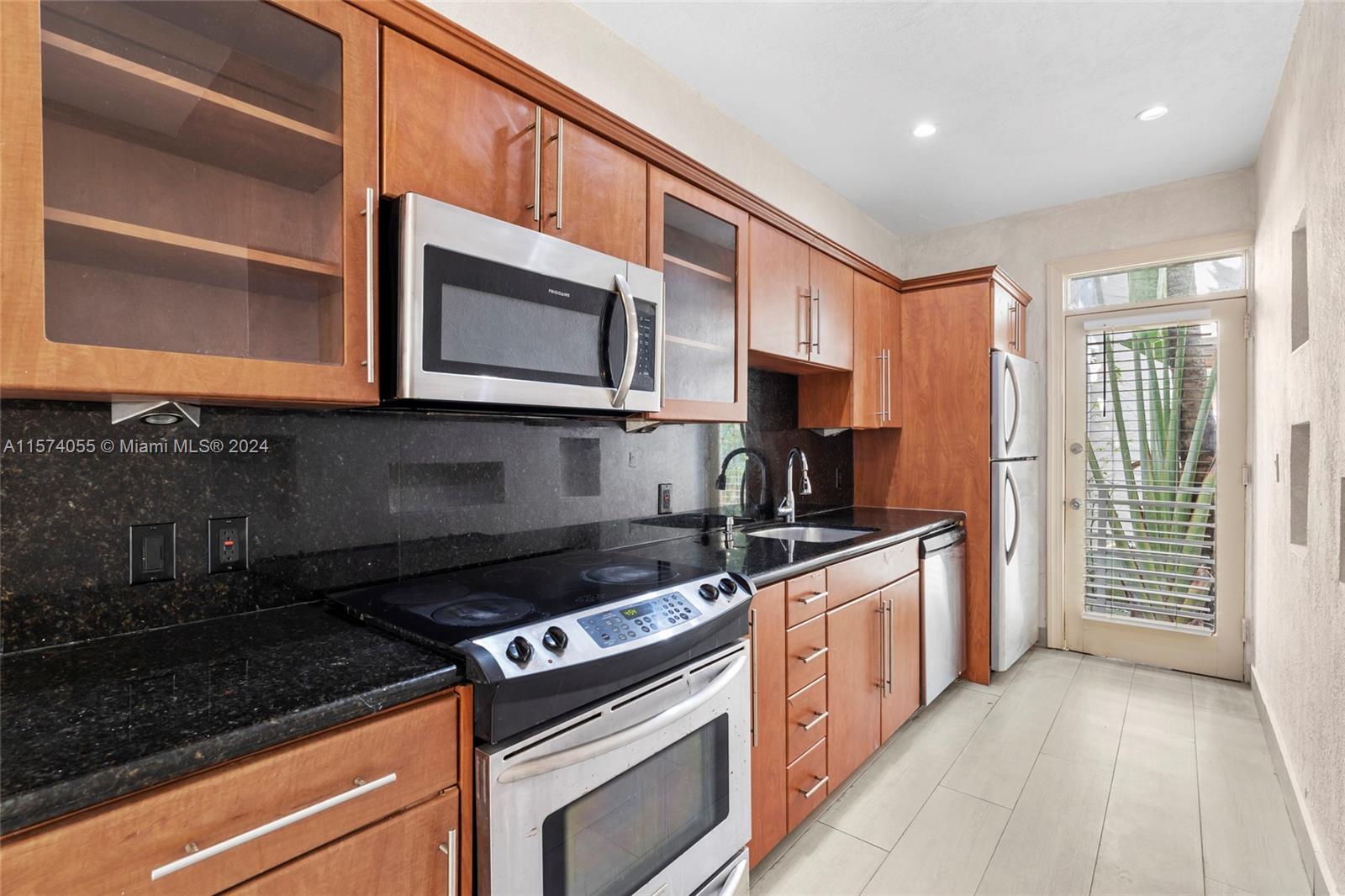 934 16th Street, Unit 5 Miami Beach, FL 33139 - Photo 6 of 22 a kitchen with stainless steel appliances granite countertop a stove and a microwave