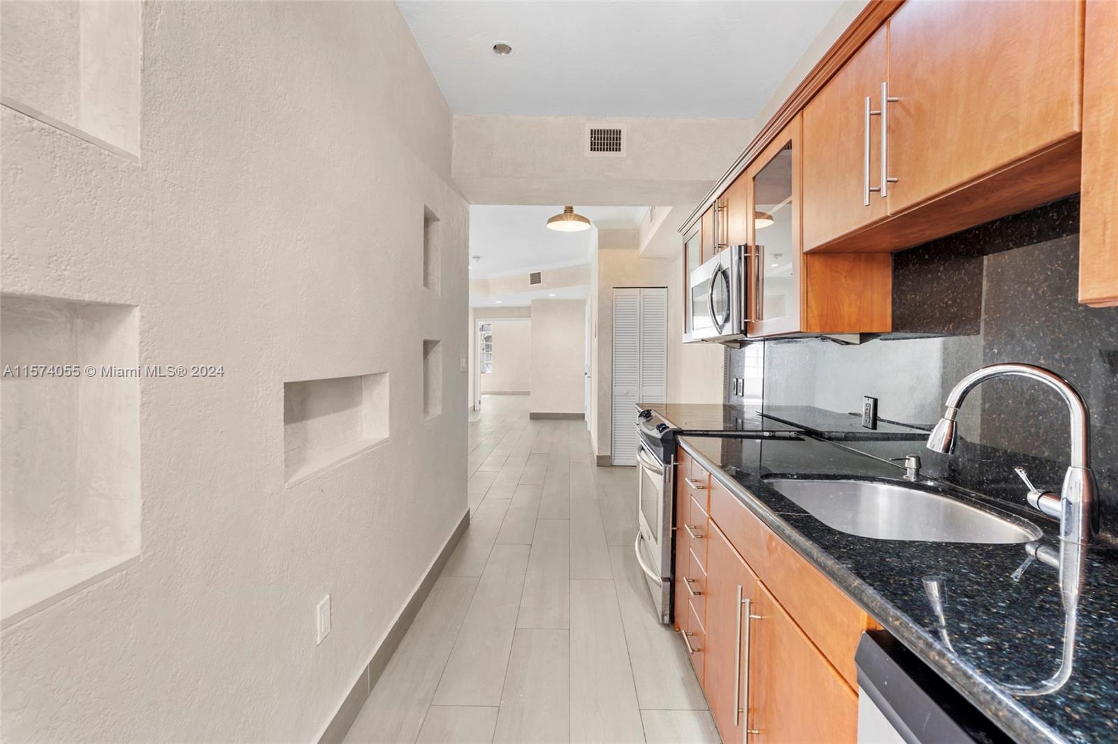 934 16th Street, Unit 5 Miami Beach, FL 33139 - Photo 7 of 22 a kitchen with granite countertop a sink stove and refrigerator