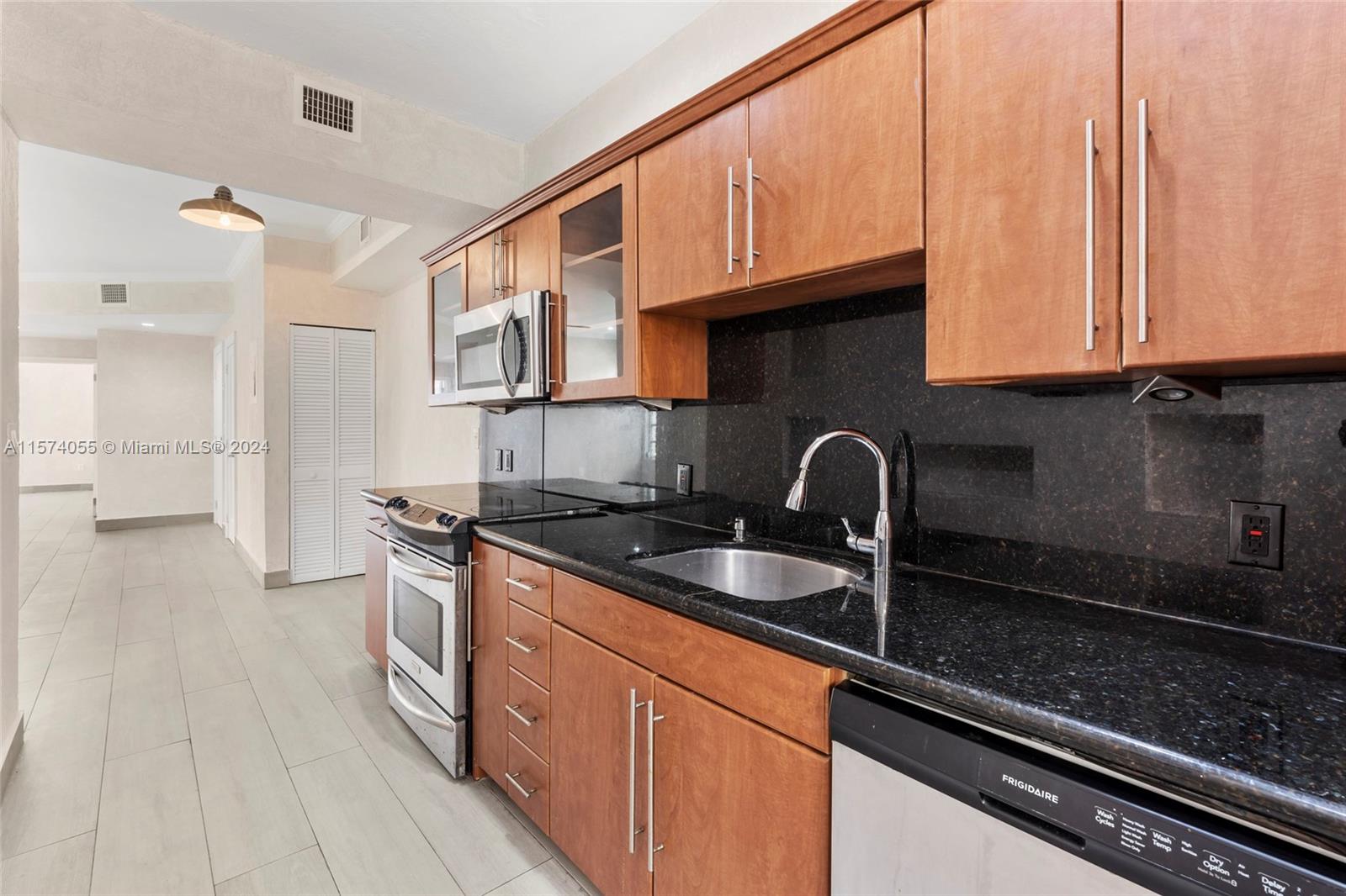 934 16th Street, Unit 5 Miami Beach, FL 33139 - Photo 8 of 22 a kitchen with stainless steel appliances granite countertop a sink and cabinets