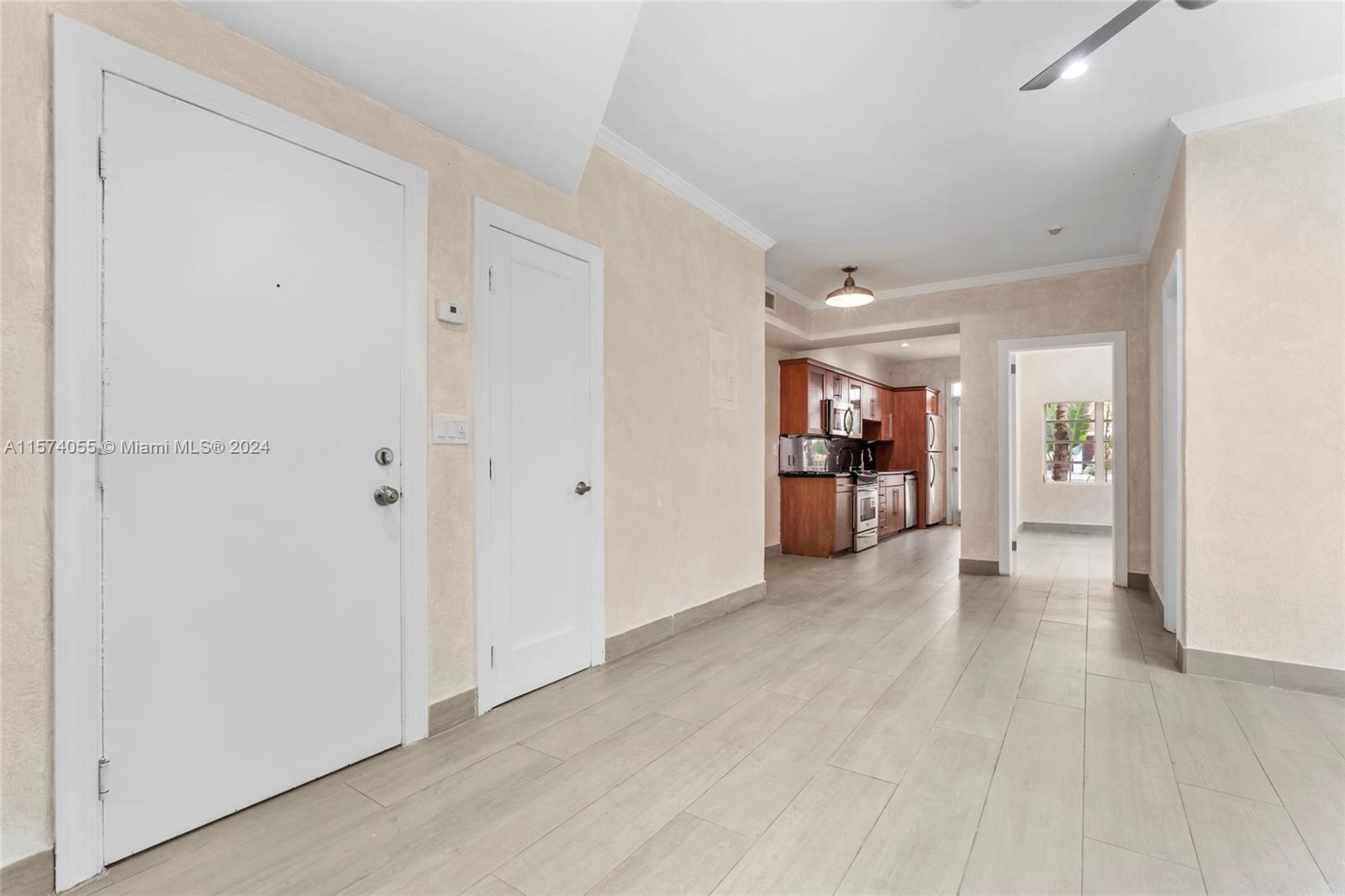 934 16th Street, Unit 5 Miami Beach, FL 33139 - Photo 9 of 22 a view of a big room with wooden floor and a kitchen