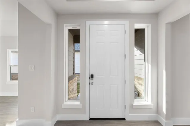 a view of an entryway with wooden floor