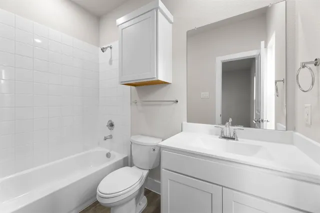 a bathroom with a sink a toilet and a bathtub