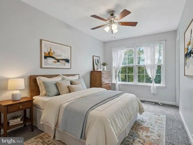 a spacious bedroom with a bed and a large window