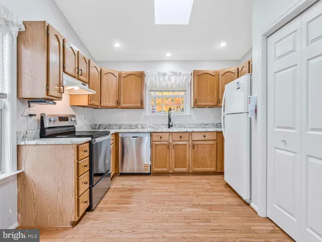 a kitchen with stainless steel appliances granite countertop a sink and cabinets