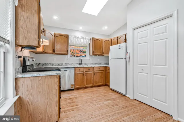 a kitchen with a refrigerator a sink and cabinets