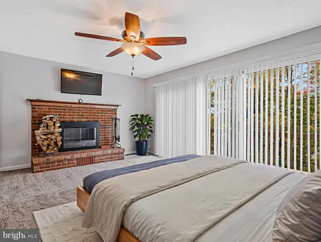 a bedroom with a bed and a fireplace