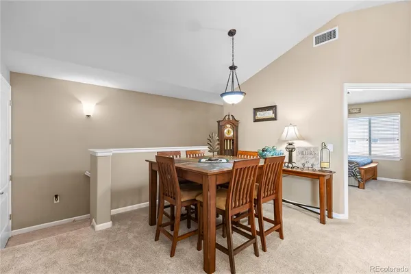 a dining room with furniture and chandelier