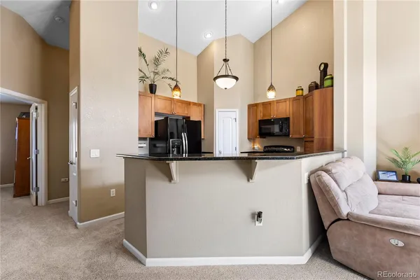 a kitchen with stainless steel appliances granite countertop a sink and a stove