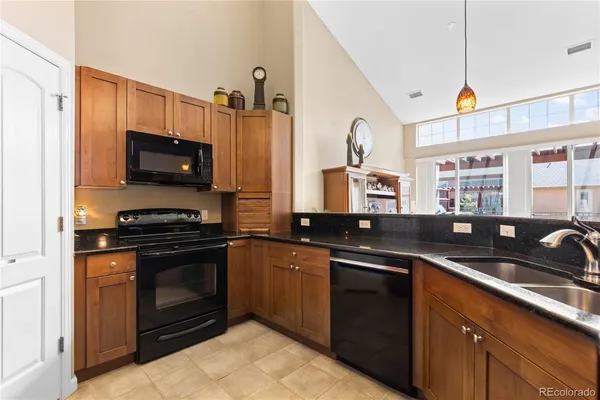 a kitchen with stainless steel appliances granite countertop a refrigerator and a stove