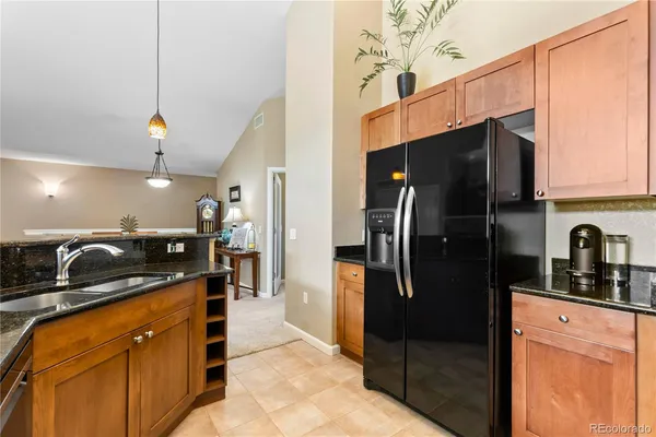 a kitchen with granite countertop a sink and cabinets