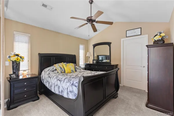 a bedroom with a bed and dresser with mirror