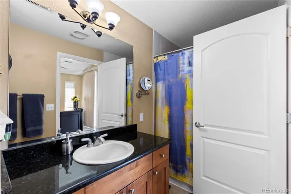 a view of walk in closet with clothes