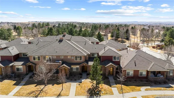 a view of a big house with a big yard and large tree