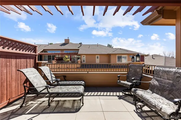 a roof deck with table and chairs