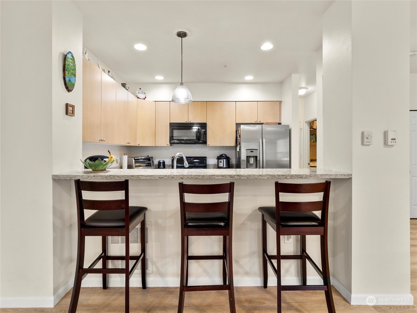 5100 Talbot Place South, Unit A Renton, WA 98055 - Photo 4 of 15 a kitchen with kitchen island cabinets and chairs in it
