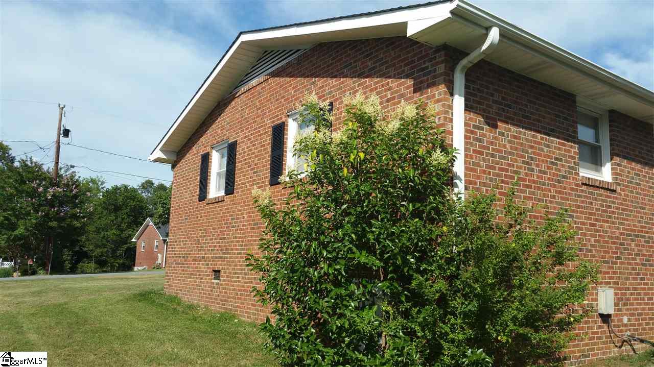 926 Winterhawk Circle Inman, SC 29349 - Photo 24 of 27 View from the backyard. Access door to crawl space is out of sight, behind bush in the corner