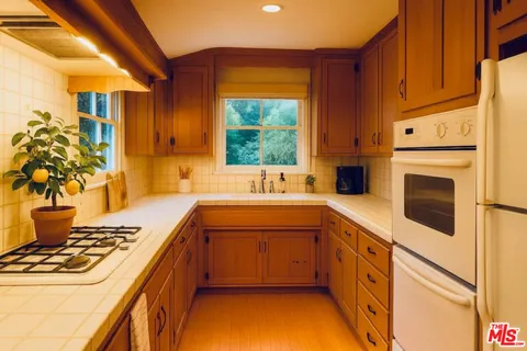 a kitchen with a stove a sink and a refrigerator