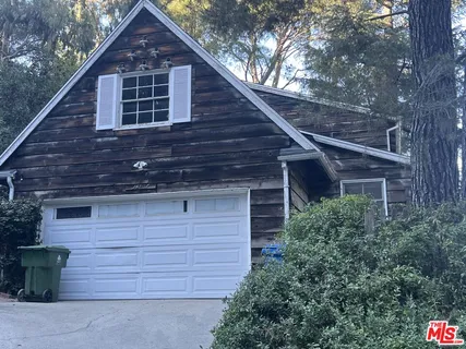 a front view of a house with garage