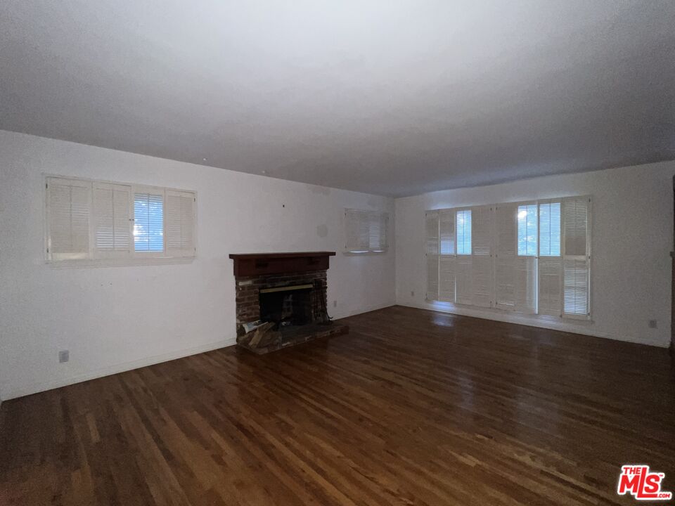 14807 Round Valley Drive Sherman Oaks, CA 91403 - Photo 8 of 25 a view of empty room with wooden floor and fan