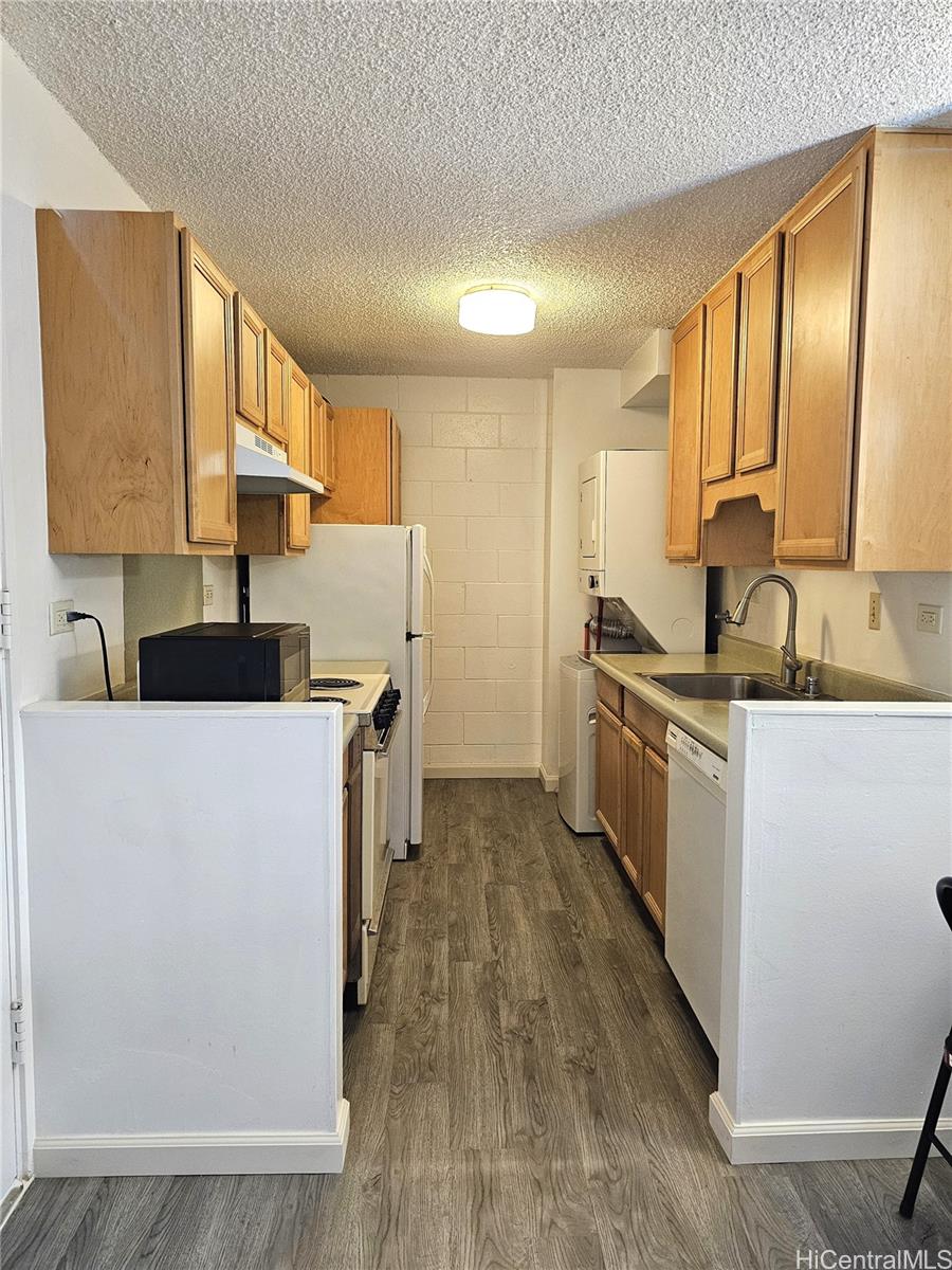a kitchen with a sink cabinets and wooden floor