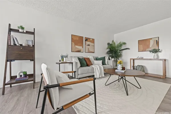 a living room with furniture and wooden floor