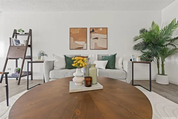 a living room with furniture and a potted plant