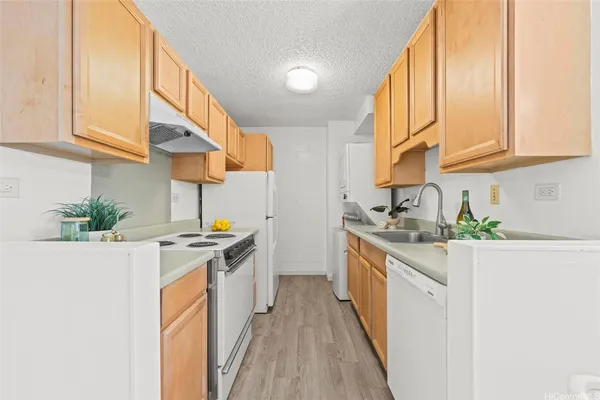 a kitchen with stainless steel appliances granite countertop a sink and a stove