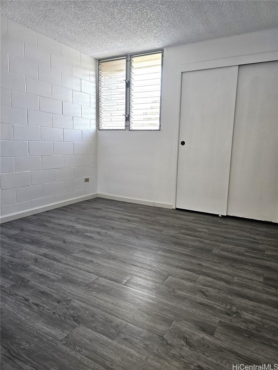 1260 Richard Lane, Unit B404 Honolulu, HI 96819 - Photo 9 of 13 an empty room with wooden floor and windows